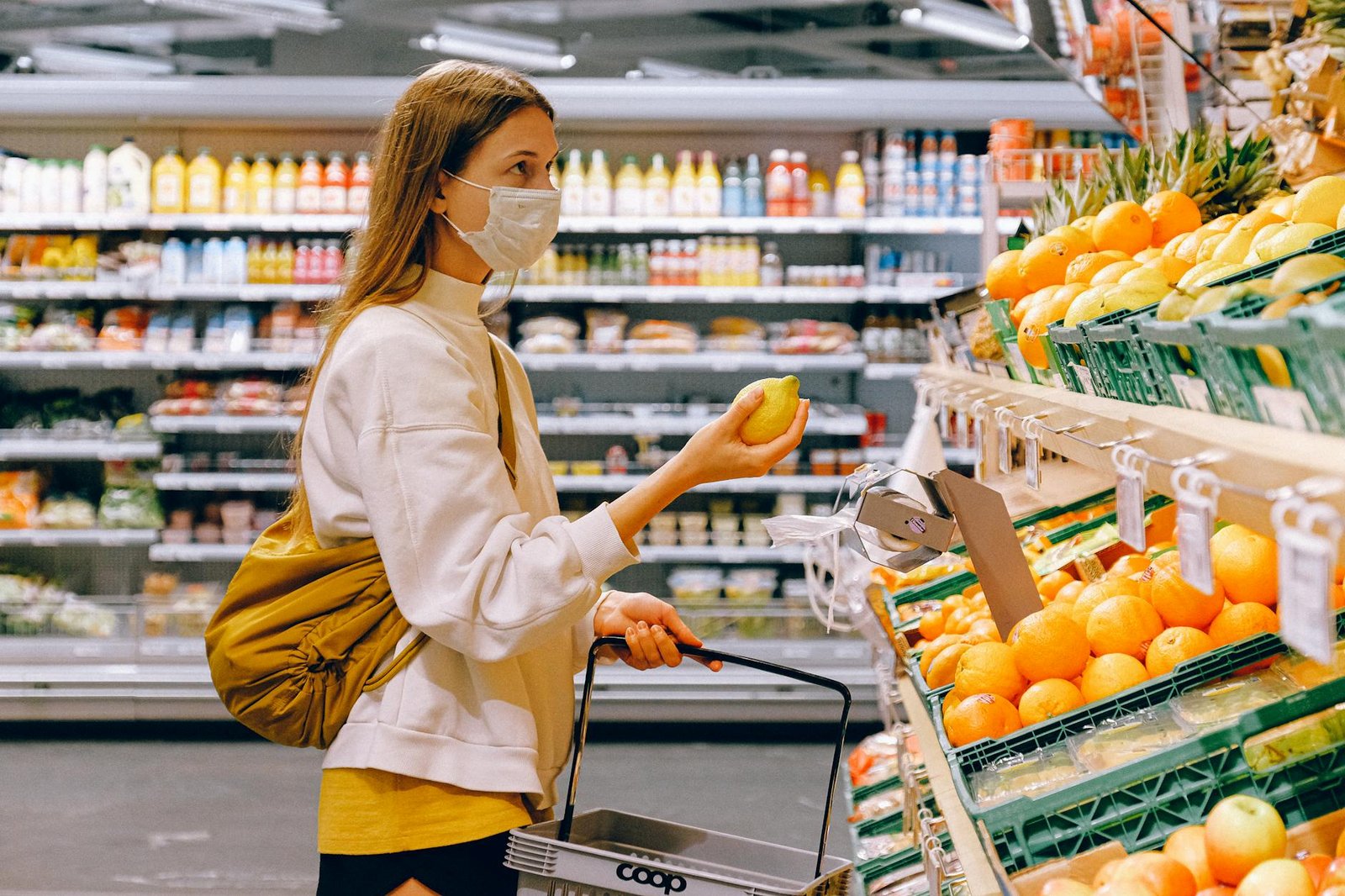 https://www.pexels.com/photo/woman-in-yellow-tshirt-and-beige-jacket-holding-a-fruit-stand-3962285/